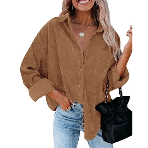 Close-up of brown corduroy fabric texture on a loose-fit long-sleeve casual shirt