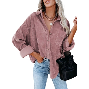 Detailed texture of dusty pink corduroy fabric on an oversized casual button-down shirt