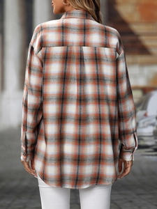 Detail of loose-fit plaid shirt back with box pleat and curved hem in orange and grey