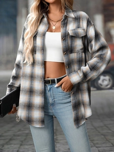 Close-up of blue and beige flannel plaid texture on this casual oversized shirt jacket