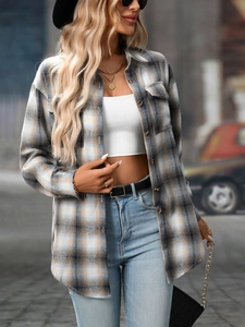 Detail of grey-blue plaid flannel shirt showing breast pocket and brushed texture