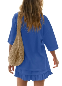 Detail of royal blue short sleeve dress with ruffled hem and knit cotton texture