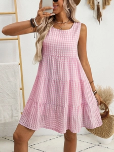 Detail of pink gingham sleeveless dress featuring a tiered flowy summer cake skirt design