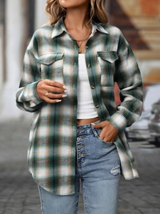 Detail of green plaid flannel shirt featuring front button closure and chest flap pockets
