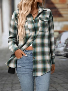 Detail of green plaid flannel shirt featuring chest pockets and amber buttons