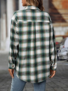 Detailed macro view of the premium green plaid flannel fabric texture and stitching