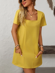 Detail of a bright yellow square neck casual dress featuring two large front pockets