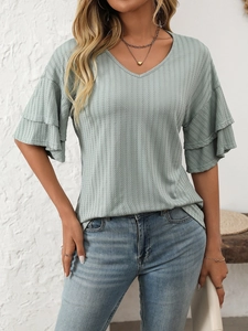 Detailed view of the V-neckline and tiered ruffle sleeves on this sage green textured top