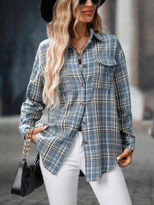 Close-up of blue plaid shirt fabric texture featuring chest pocket and button details