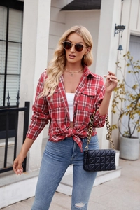 Detail of red and white plaid flannel shirt with front pockets and front knot styling