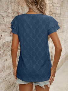 Detail of navy blue short sleeve top featuring hollow diamond texture and ruffled cuffs