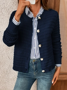 Detail of navy knit cardigan featuring textured checkerboard pattern and white buttons