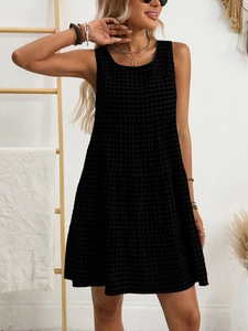 Close-up of lightweight black gingham fabric and tiered stitching on a summer dress