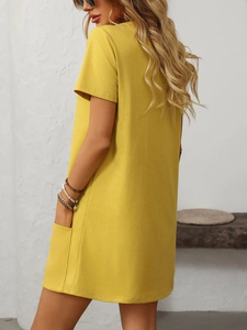 Detail view of practical side pockets on a yellow short-sleeve square neck casual dress