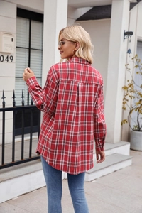 Detail of red and white plaid flannel shirt showing the inverted pleat and curved hemline