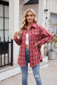 Detail of red plaid long sleeve shirt showing chest pocket and wooden style buttons