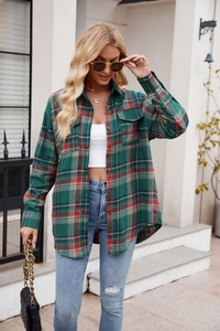 Detail of green and red plaid flannel shirt with dual chest pockets and button-front