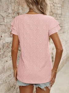 Detail of pink short sleeve top featuring hollow diamond jacquard and layered ruffle sleeves