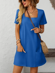 Detail shot of navy blue square neck dress featuring two functional front patch pockets