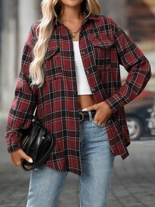 Close-up of red and black plaid flannel shirt featuring dual chest pockets and classic buttons