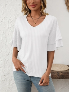 Close-up of white V-neck top featuring layered ruffle sleeves and vertical ribbed texture