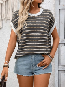 Close-up of crewneck knit top showing the striped pattern texture and ribbed cuffs