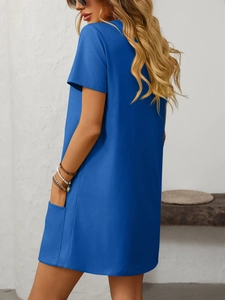 Detail view of royal blue short sleeve dress showing the functional side pocket and knit fabric