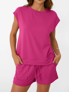 Detail of rose pink two-piece set featuring round neck top and drawstring shorts with pockets