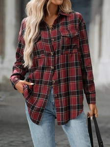 Detailed close-up of red and black checkered flannel shirt with chest pockets and buttons