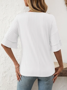 Rear view of white V-neck top with layered ruffle sleeves and vertical textured fabric