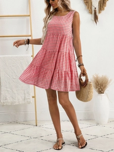 Detail of red and white gingham sleeveless tiered dress for women in bohemian setting