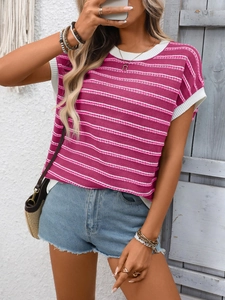 Close-up of pink and white striped knit top with ribbed edges and denim shorts detail
