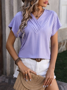 Close-up of women's purple V-neck short sleeve top with vertical rib textured fabric