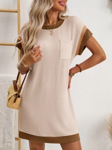 Detail of contrast stripe hem and textured knit fabric on beige short sleeve dress