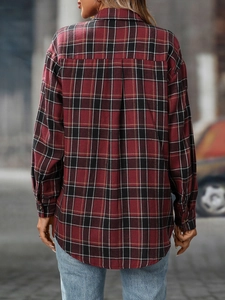 Back view of a casual oversized red plaid shirt with drop shoulders and pleat detail