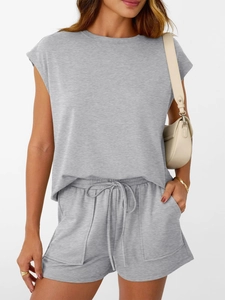 Detail of grey knit two-piece set featuring short sleeve top and drawstring shorts