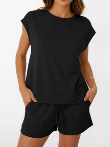 Detail of black women's lounge set featuring drawstring shorts and crew neck cotton top