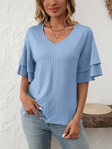 Detail of light blue V-neck top showing triple-layered ruffle sleeves and ribbed texture