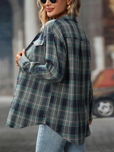 Close-up of green and blue plaid shacket with chest pockets and oversized fit