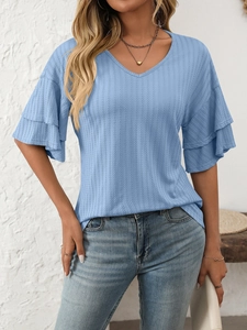 Detail of light blue V-neck knit top showing layered ruffle sleeves and ribbed texture