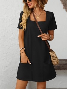 Close-up detail of a casual black square neck mini dress with two functional front pockets