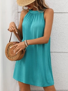 Detail of lake green halter neck dress with pleated texture for summer vacation style