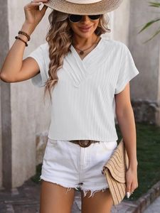 Detail of white V-neck jacquard top with textured stripes and casual summer style