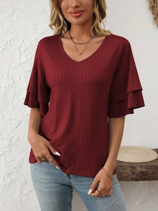 Detail of V-neck knit top in burgundy featuring elegant double-layered ruffle sleeves