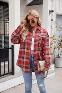 Close-up of red plaid flannel shirt detailing chest pockets and classic button-down front