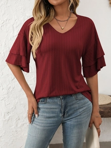 Detail of burgundy V-neck top with ribbed texture and elegant double ruffle sleeves