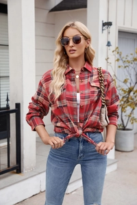 Detail of red and blue flannel plaid shirt with chest pockets and metal buttons