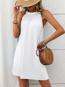 Detailed macro view of the textured white fabric on a halter neck mini dress