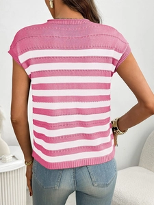 Back view of summer knit top with pink and white stripes and ribbed hem on denim jeans