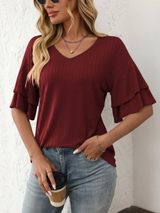 Close-up of wine red V-neck top showing ruffled sleeves and vertical striped texture